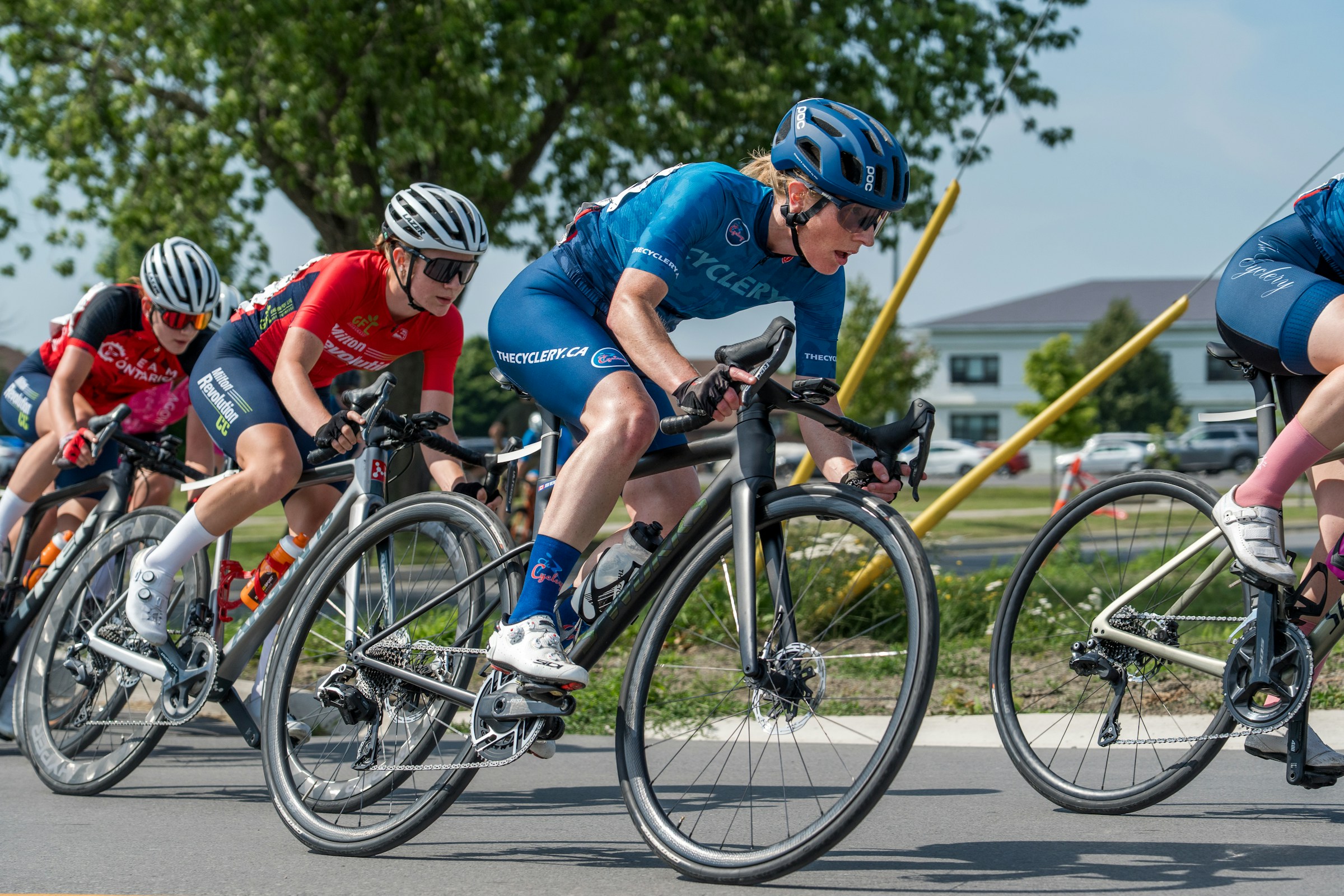 Cyclists racing on a road during a competitive charity cycle event