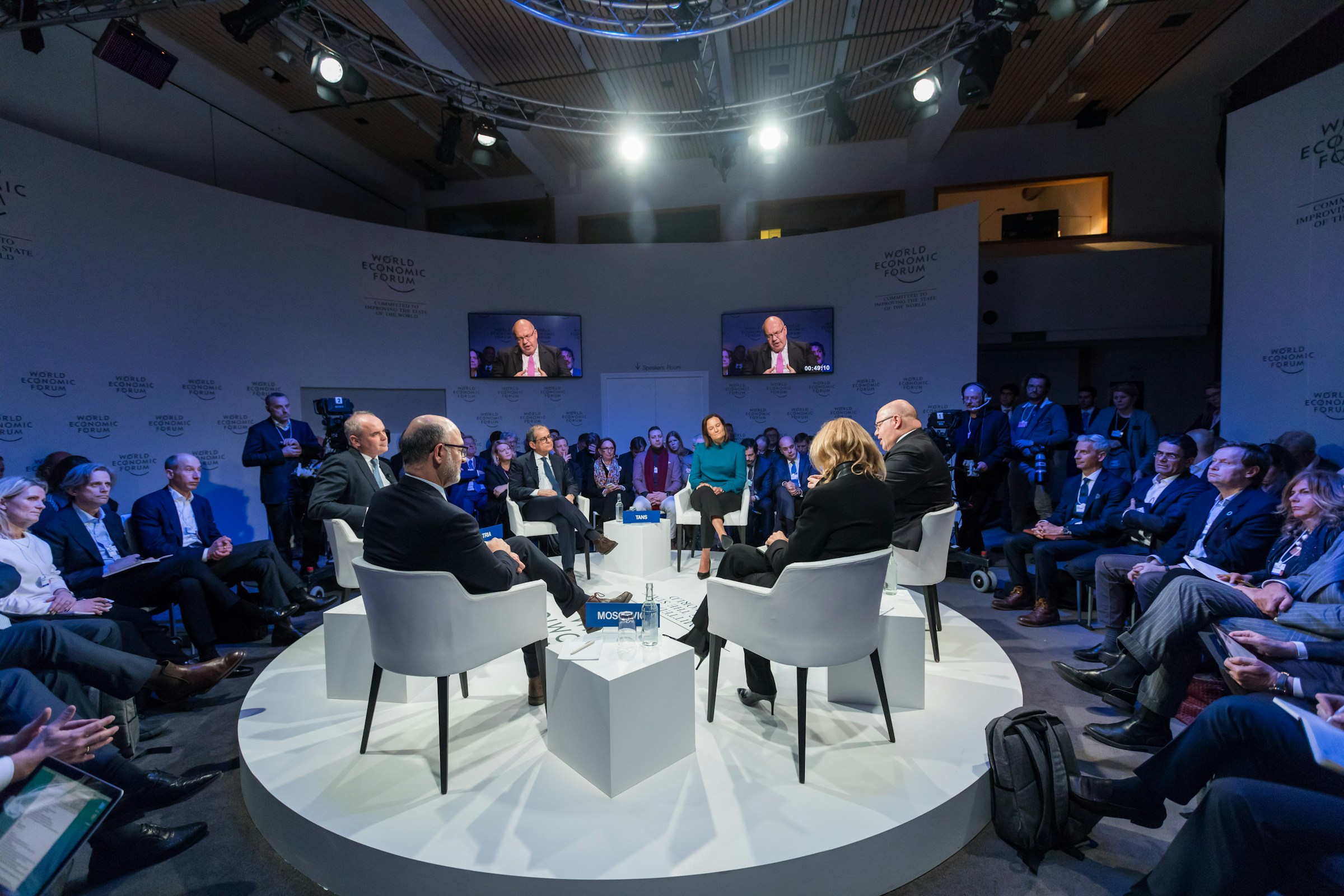 Panel discussion on stage at a corporate conference with an audience
