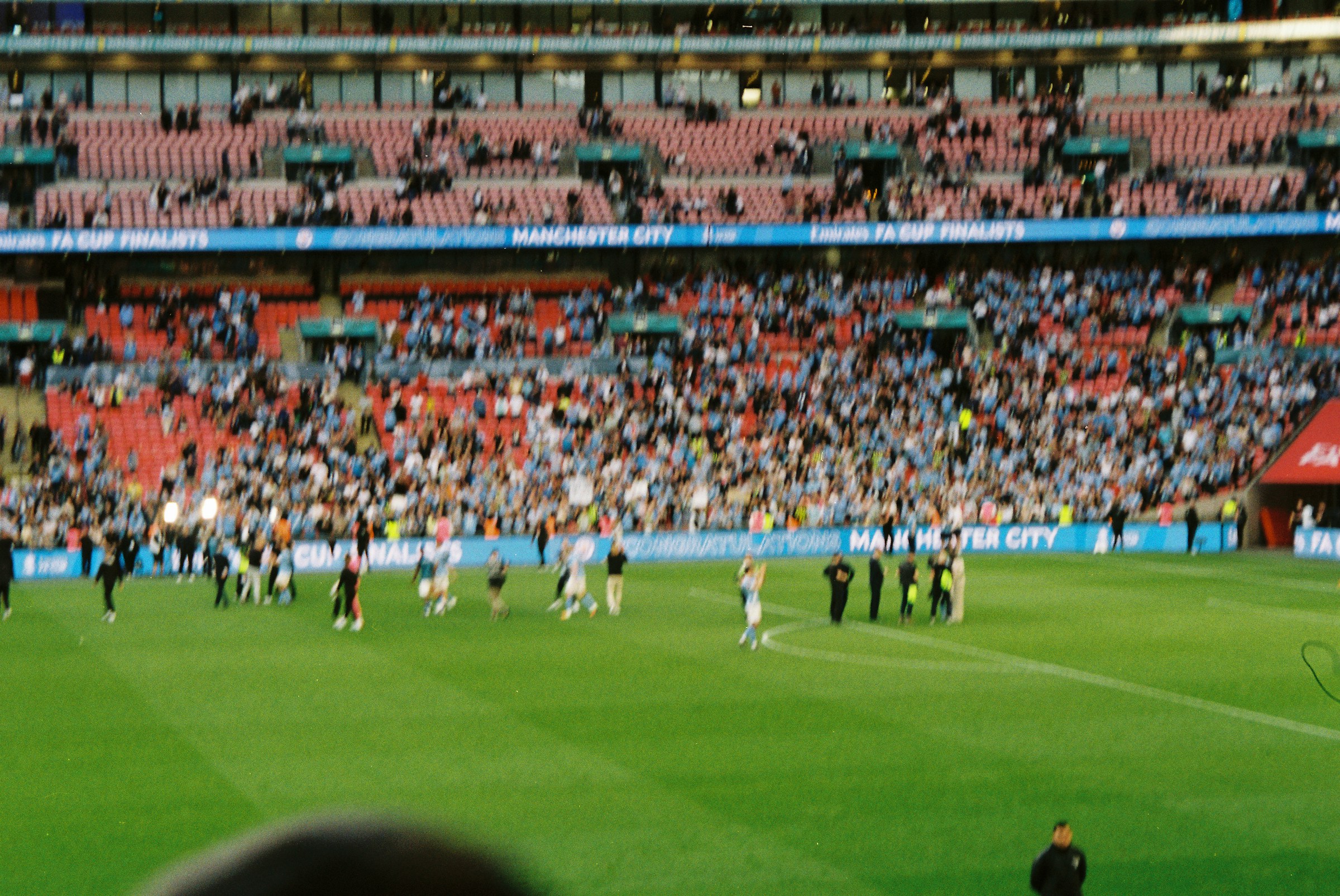 Crowd watching a match from the stands at a large stadium